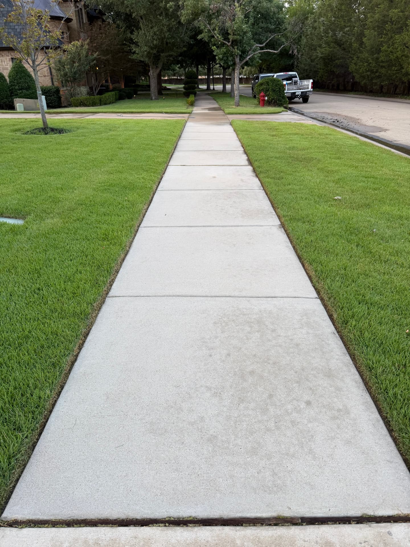 After — Residential concrete sidewalk before and after pressure washing